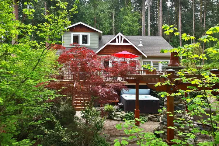 Relax in the hot tub in the serene yard