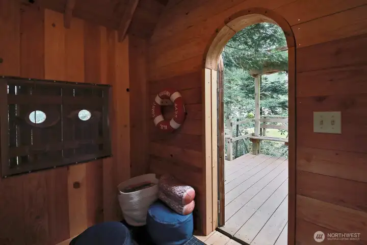 Inside the tree house. Seating pads and windows open.
