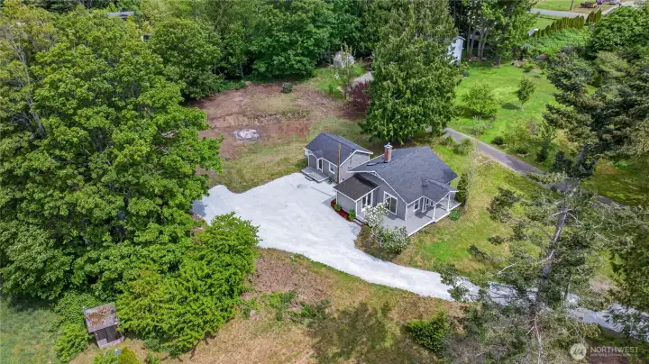 Set on a private and usable 1.37-acre lot, this unique property features an updated main home plus a detached guest cottage.