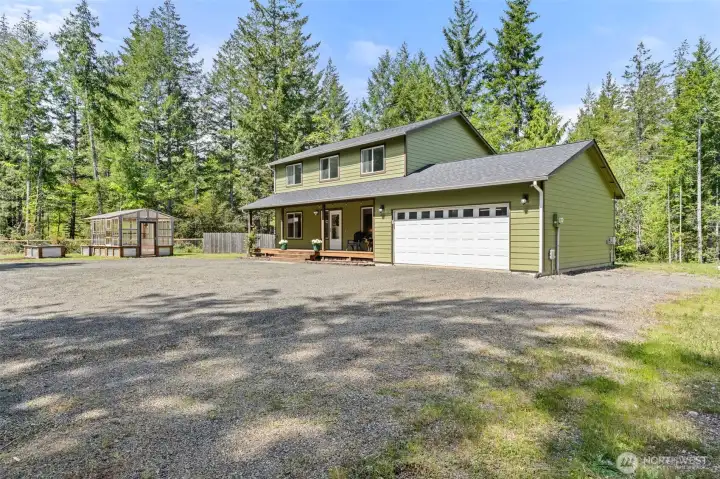 Front of house with RV parking spot with hookups on side of house