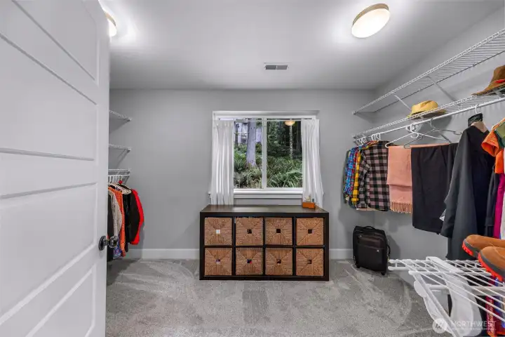 Huge walk-in closet in primary suite has its own opening window Huge walk-in closet in primary suite has its own opening window