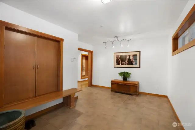 Spacious foyer with huge closet, bench and French pocket doors to the heart of the home