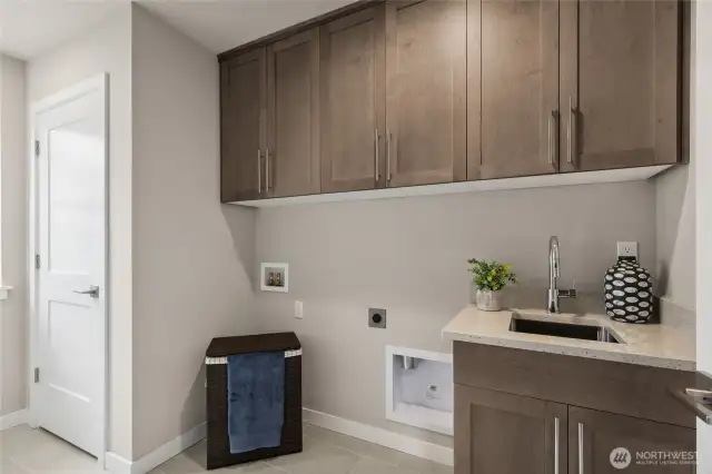 Laundry features built in sink & upper cabinets as standard. Photos are for representational purposes only.  Colors and options may vary.