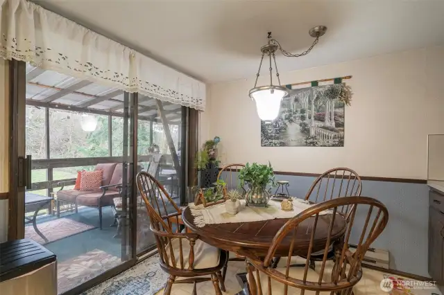 Slider leads out to roomy covered back deck that overlooks a lovely hillside side yard, privacy at its finest.