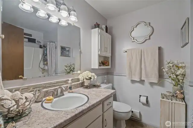 Down the hall the main full bath has been recently updated with new paint, countertops, and fixtures.