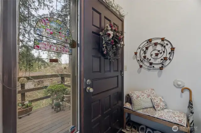 Entry landing front door leads out onto spacious front deck.