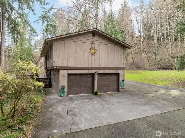 Plenty of room for parking here, including a gravel pad that runs along back side of house, perfect for RV or other toys.