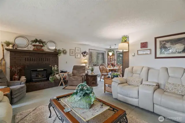 The living room opens into a good sized dining room with more large windows to  the welcome the beautiful sweeping outside greenbelt in.