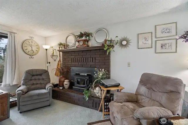 This fireplace with wood-burning stove insert can keep the upstairs warm and cozy on a long dark Winter's day!