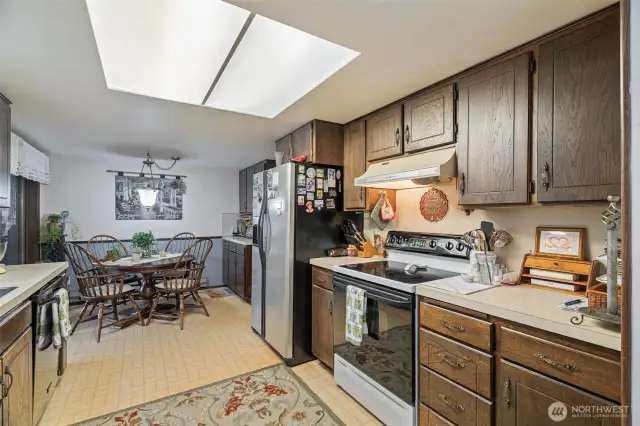 This bright, tidy kitchen is perfectly laid out for all your kitchen needs with extra storage in breakfast nook.