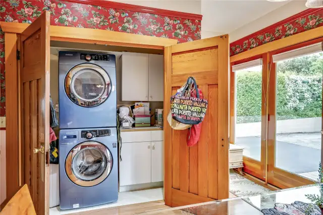 Behind these beautiful wood doors are the stackable washer and dryer for convenience.