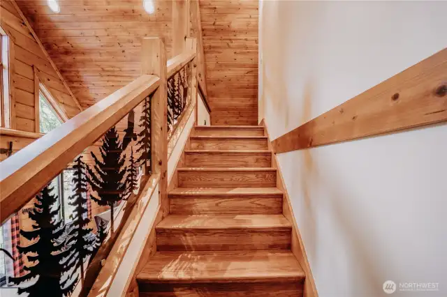 Custom staircase leads to an upper loft (3rd bedroom) with ensuite bath
