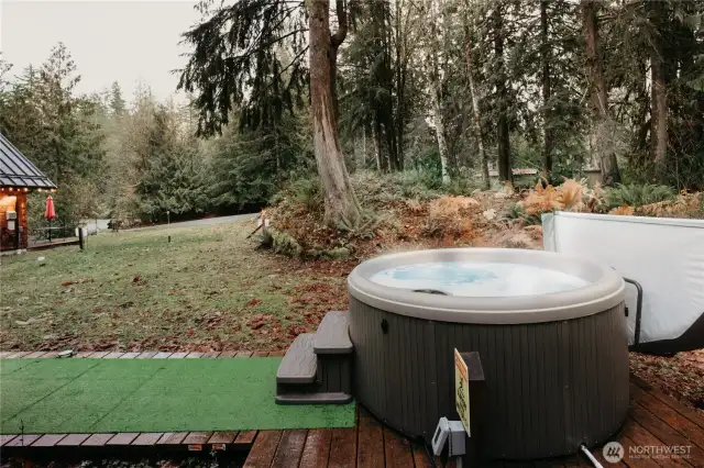 The deck extends off the back porch to the hot tub for post-slope relaxation