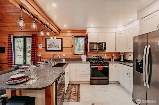 The gourmet kitchen beautifully blends rustic accents with modern design and features counter seating & walk-in pantry