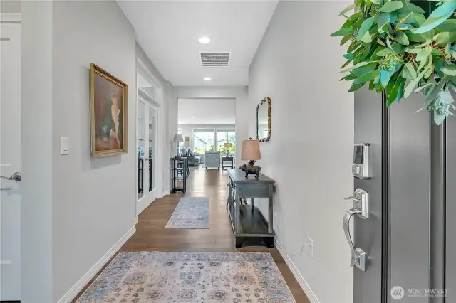 Front Entry. Guest Suite to immediate Left. Den/Office through Glass French Doors ahead on left. Straight ahead to the Open Concept Kitchen/Dining/Lounge/Great Room.