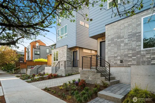 A welcoming private entry accented by vertical cedar slats and sleek black trim creates a stylish first impression.