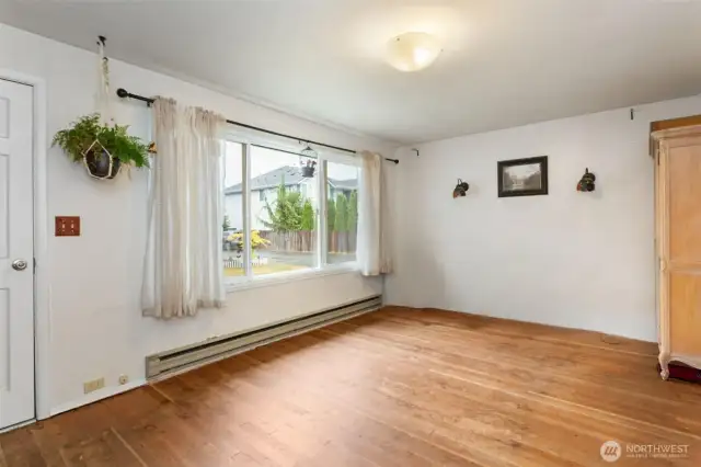 Living room as it is currently with carpet removed.  Hardwood floors were underneath and seller liked them better.