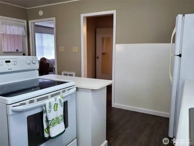 Another view of kitchen looking into living room and hallway to bedroom