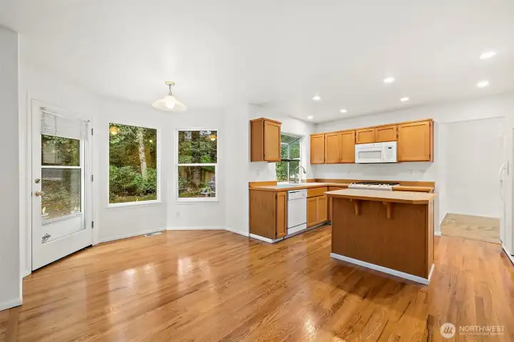 The kitchen and family room have beautiful red oak hardwood floors.  They are truly beautiful. Also, there is a door that leads you out to the new composite back deck.