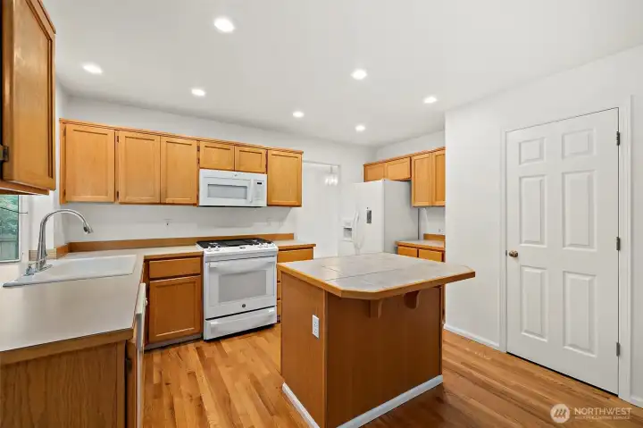 "Enjoy cooking on the newer gas cooktop and oven with built-in air fryer! The door on the right leads to a roomy pantry.