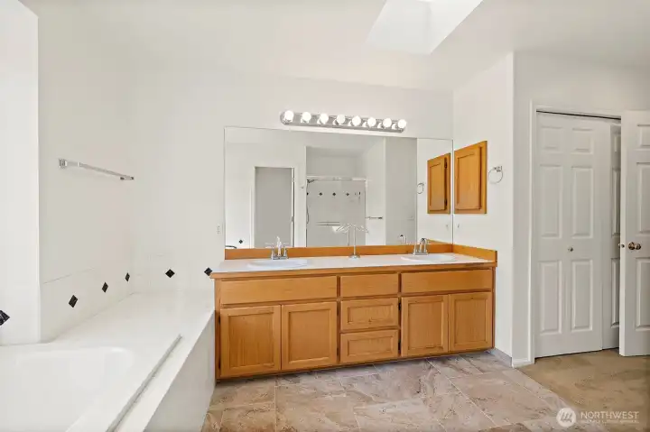 Primary bedroom with double sinks, an closet access.