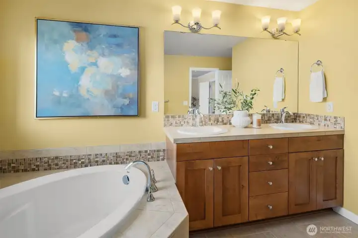 Primary ensuite featuring dual vanities.