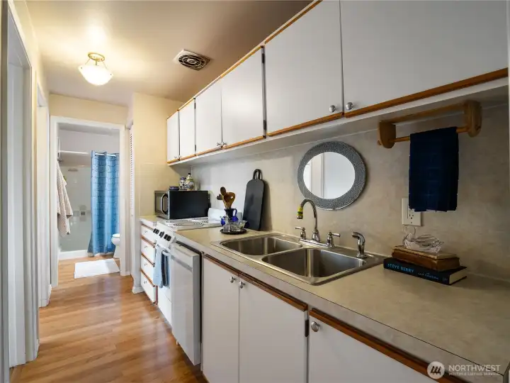 The galley style kitchen is compact and efficient. All appliances stay with the home.