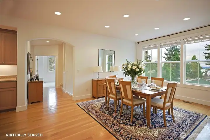 Spacious dining room w/ a wall of windows to take in the partial views of Saratoga Passage & Whidbey Island.