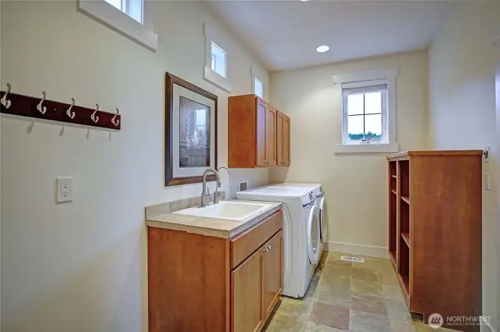 The laundry room has a utility sink & storage.