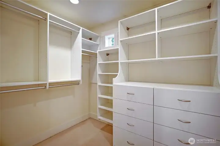 Primary walk-in-closet w/ built -ins.