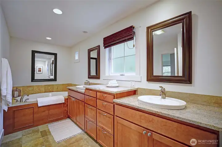 Double vanities w/ lots of storage & a jetted soaking tub.