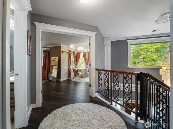 upstairs landing area with inviting french doors to primary bedroom