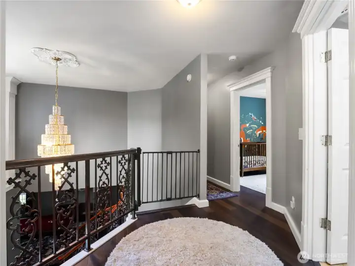 landing area with peekaboo view into one of the additional bedrooms