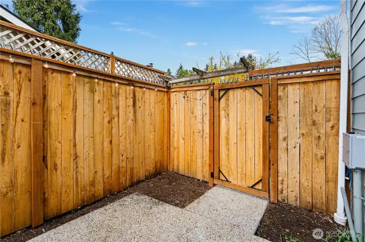 Off of the kitchen, find the fully fenced off back patio with privacy fencing.