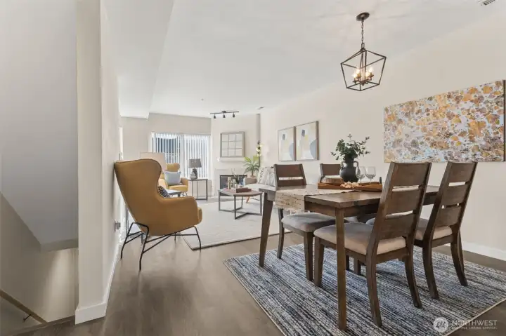 Up the stairs, you will enter into the large, open great room, where the living space, dining area and kitchen all flow into one. Modern living is enhanced with smart home upgrades throughout, including smart light switches, a smart thermostat, a smart garage door opener, and an EV charger outlet—perfect for eco-conscious buyers or anyone seeking added convenience and efficiency.