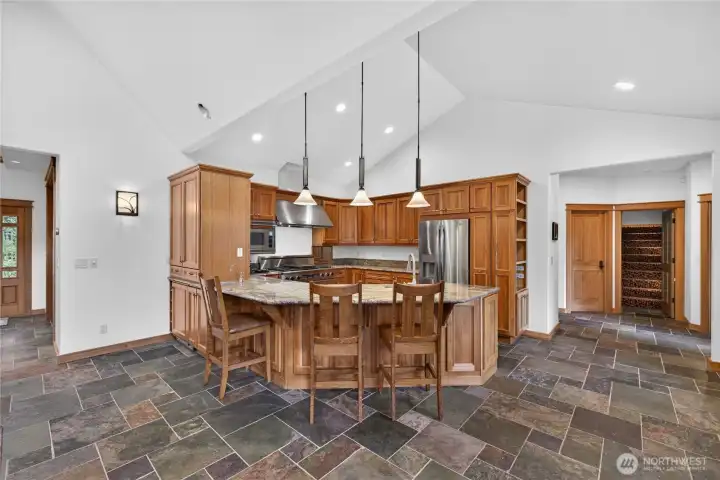 Front entry on the left & laundry and garage access behind the kitchen with primary bedroom to the far right of the stairs