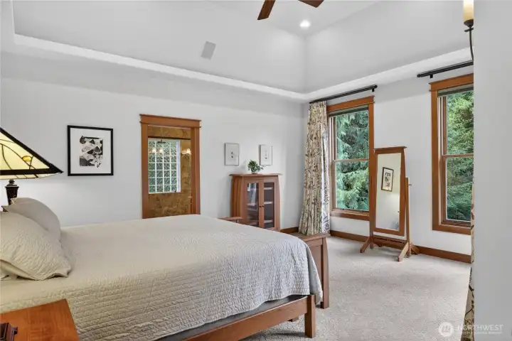 Primary bedroom with custom Howard blinds on main level