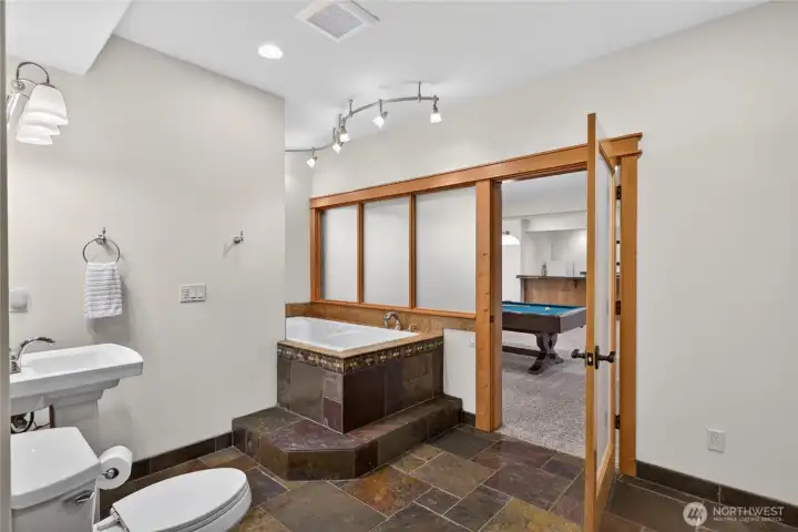 Lower level bathroom with soaking tub and ready for sauna install