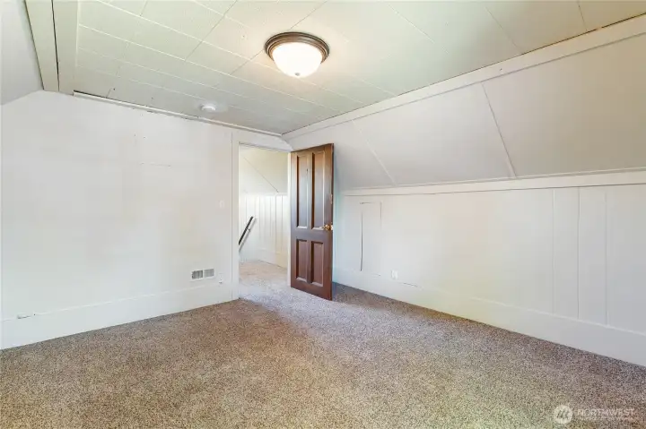 Upstairs space looking to an additional landing area and the stairs. Upstairs space looking to an additional landing area and the stairs.