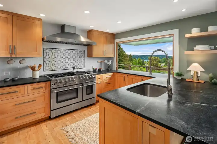 Stainless steel appliances adorn this roomy kitchen. Check out the swing-out window for easy entertaining and fresh air!!