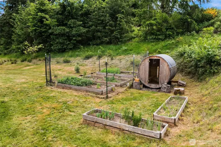 A fenced, quaint kitchen garden sits next to your sauna.