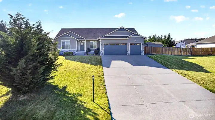 Welcome home to this beautifully maintained rambler featuring attractive stone accents, manicured landscaping, and a three-car garage!