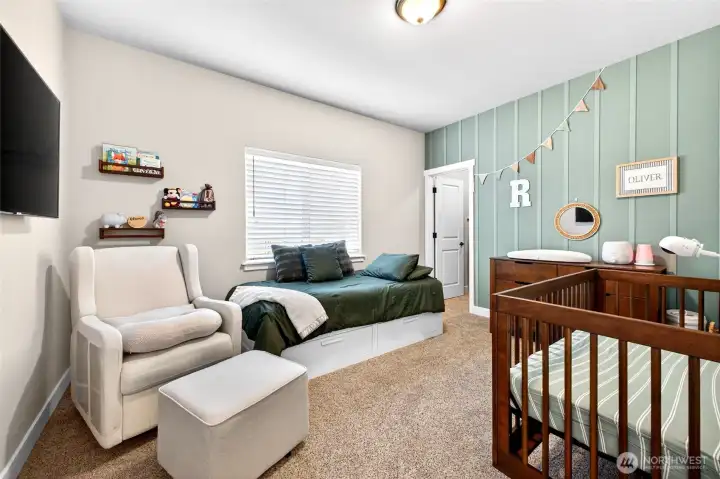 Comfortable bedroom with ample natural light, generous closet space, and room for guests.