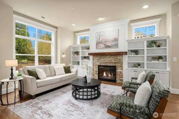 Another angle of the living room highlights the generous layout, abundant natural light, and the beautifully appointed fireplace flanked by custom built-ins — a warm and elegant space designed for both relaxing and entertaining. Another angle of the living room highlights the generous layout, abundant natural light, and the beautifully appointed fireplace flanked by custom built-ins — a warm and elegant space designed for both relaxing and entertaining.