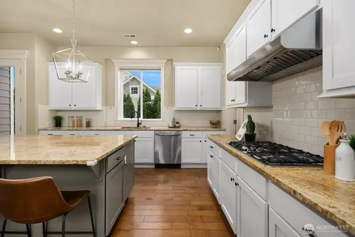 This angle showcases the kitchen's premium gas cooktop, classic subway tile backsplash, and stone countertops — beautifully crafted details that elevate this space into a truly high-end culinary experience. This angle showcases the kitchen's premium gas cooktop, classic subway tile backsplash, and stone countertops — beautifully crafted details that elevate this space into a truly high-end culinary experience.