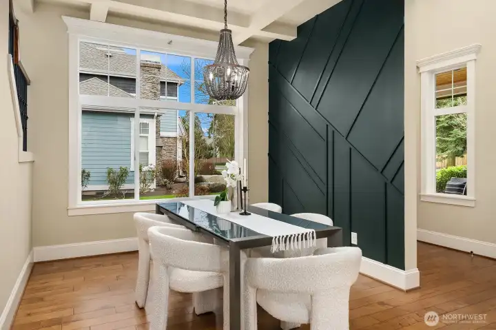 The formal dining room makes a bold statement with a dramatic accent wall, elegant chandelier, and rich hardwood floors — a sophisticated and stylish space perfectly suited for memorable dinner parties and holiday gatherings. The formal dining room makes a bold statement with a dramatic accent wall, elegant chandelier, and rich hardwood floors — a sophisticated and stylish space perfectly suited for memorable dinner parties and holiday gatherings.