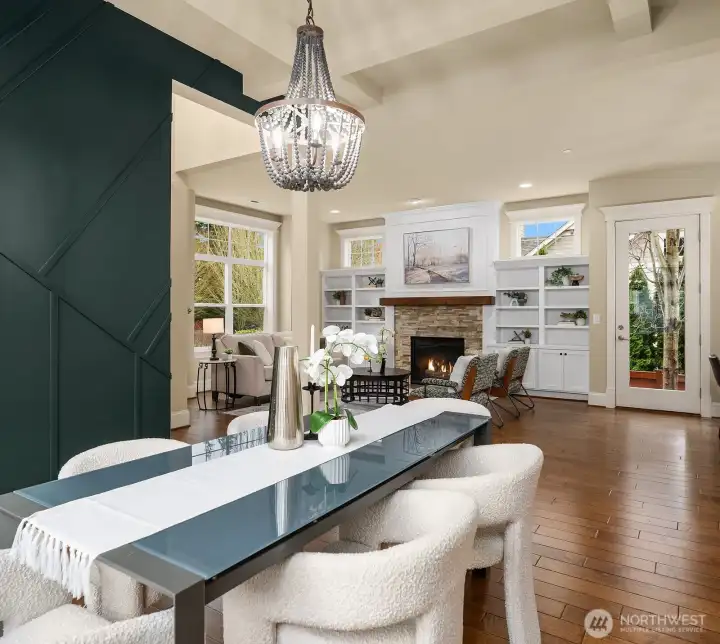 Another angle of the dining room showcases the stunning accent wall, elegant chandelier, and seamless connection to the living room beyond — a beautifully designed space that is as functional as it is visually striking. Another angle of the dining room showcases the stunning accent wall, elegant chandelier, and seamless connection to the living room beyond — a beautifully designed space that is as functional as it is visually striking.