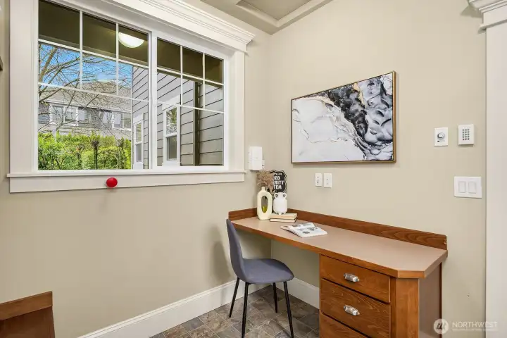 A charming built-in desk nook offers a quiet and dedicated workspace, tucked away with a bright window and warm wood tones — a thoughtful detail that adds everyday functionality to this well-designed home. A charming built-in desk nook offers a quiet and dedicated workspace, tucked away with a bright window and warm wood tones — a thoughtful detail that adds everyday functionality to this well-designed home.