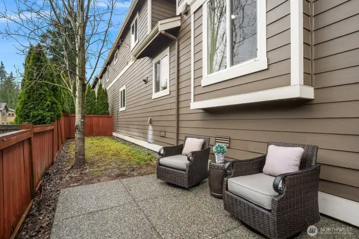 The private patio offers a charming outdoor retreat with comfortable seating and a fully fenced yard, framed by the home's classic exterior — a perfect spot for relaxing or enjoying the fresh Pacific Northwest air. The private patio offers a charming outdoor retreat with comfortable seating and a fully fenced yard, framed by the home's classic exterior — a perfect spot for relaxing or enjoying the fresh Pacific Northwest air.