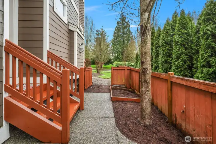 The home's exterior walkway and staircase highlight the corner lot setting, with mature evergreen trees providing a beautiful natural backdrop and a separate entrance that leads conveniently to the above-garage ADU. The home's exterior walkway and staircase highlight the corner lot setting, with mature evergreen trees providing a beautiful natural backdrop and a separate entrance that leads conveniently to the above-garage ADU.